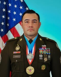 photo of MSG Sean Ambriz in dress uniform displaying his medals 
